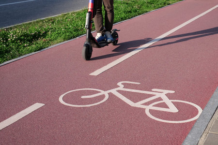 Bike path on the asphalt road and scooter. Selective focus.