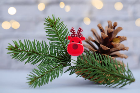 Christmas composition with fir branches decorated with the symbol of 2021 bull cow and red gift box...