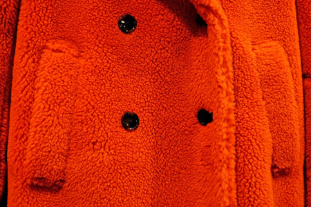Faux fur jacket close-up, orange color, eco-style