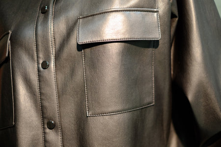 Background black leather texture colose-up with buttons and pocket. Part of a leather jacketの写真素材