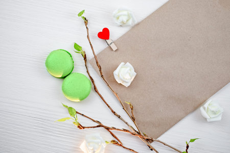 Macaroons number 8, envelope mock-up, and fresh leaves. March 8 celebrate. Copy space.