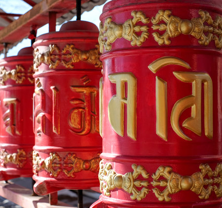 Buddhist prayer wheels drums in datsan Gunzechoyney in Saint-Petersburg, Russia. Sunlight and shadows, selective focus, close-upの写真素材
