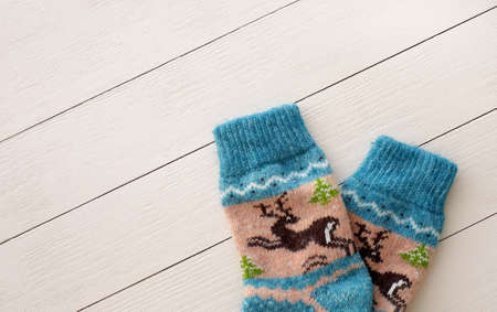 Traditional Christmas woolen socks with deers on wooden background with copy spaceの写真素材
