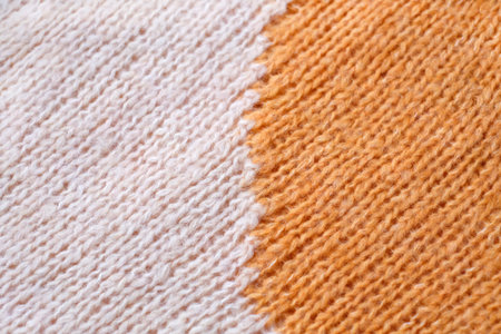 White and yellow woolen natural texture, knitted textile background, close-upの写真素材