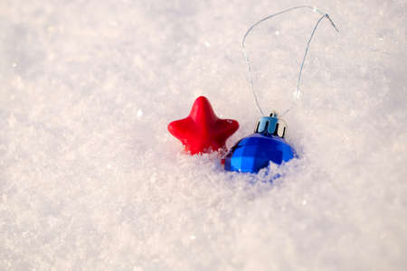 Christmas ball and star on snow background, copy spaceの写真素材