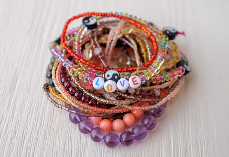 Love word beads bracelets close-up on wooden backgroundの写真素材