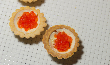 tartlets with butter and red caviar on a white background, a delicious treat for the holidayの写真素材