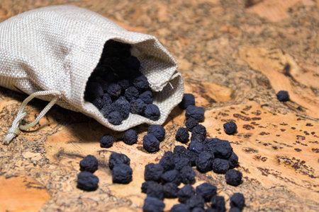 a dried aronia berry was spilling out of a canvas bagの写真素材