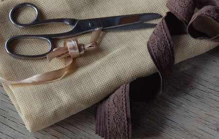 scissors, tape, and fabric in shades of brown for needleworkの写真素材