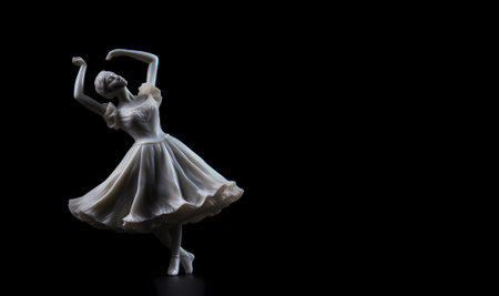 Statuette of a girl dancer, plaster, white figure, goddess of beauty on a black background. free spaceの素材