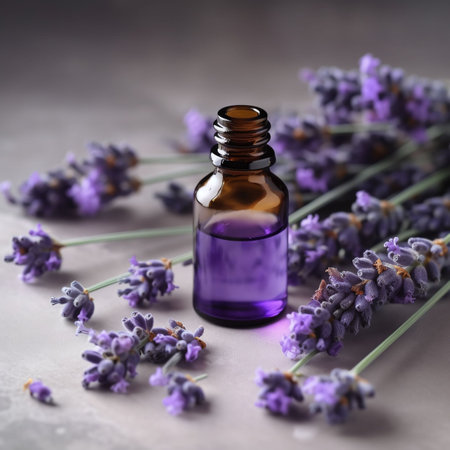 essential, lavender oil in a bottle and lavender flowers on a wooden surfaceの素材