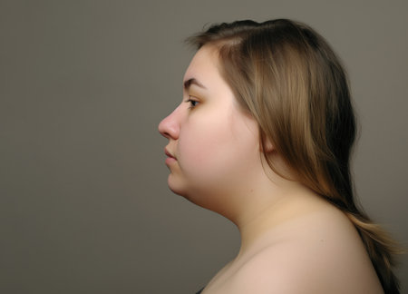 Portrait of a young beautiful girl on a gray background in the studioの素材