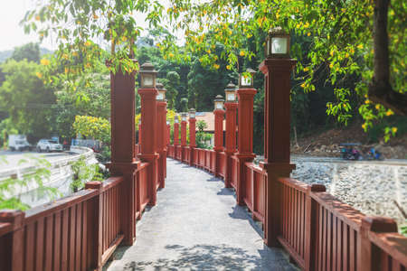 The wooden red-painted bridge in Krabi, Thailand. Chinese style Red Bridge.の写真素材