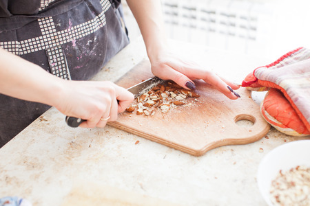  The concept of cooking. The confectioner cuts the almonds for the cake.の写真素材