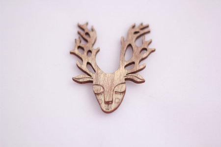 Deer on white background, brooch made of woodの写真素材