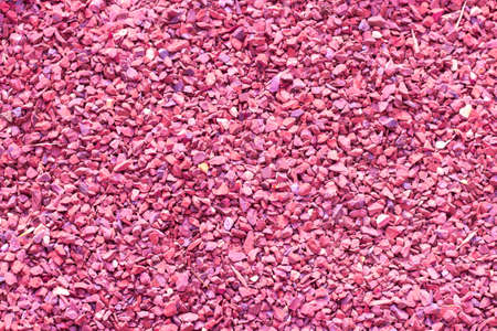 Pebbles, small pebbles, granite marble chips, textured useful eco-friendly coating of footpaths. Building material stone crumb pink color, background backdrop textureの写真素材