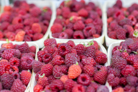 Fresh ripe raspberries in birch bark boxes. Wooden trays with red raspberries, food nature...