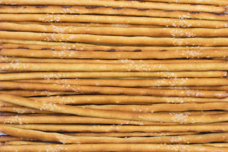 Salted dough straw, salted mkreker snack, crispy breadsticks, close-up background, horizontal pattern and bakery productsの写真素材