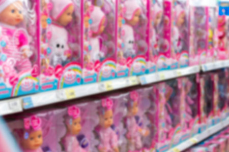 Defocus background, children's store showcase with large dolls in pink boxes, toy store for childrenの写真素材