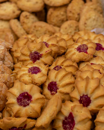 Shortbread cookies with a drop of jam, a lot of a bunch of sweet pastries. curabier dessert vertical backgroundの写真素材