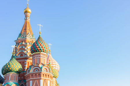 St. Basil Cathedral in Moscow on Red Square on a background of clear clear blue sky, copy space poster. Beautiful multi-colored roofs of poppies, the orthodox church, a tourist attraction in Moscowの写真素材