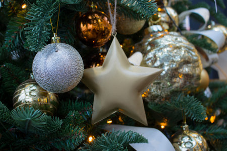 Brilliant toys on the Christmas tree, New Year and Christmas. Place for your congratulations. Silver...