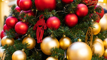 Christmas tree decorated with gold and red balls space style. Toy astronaut on a Christmas tree, close-up. Background backdrop wallpaper New Year decoration Christmasの写真素材