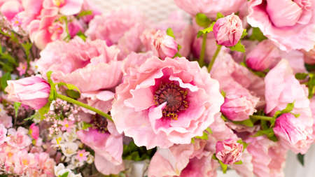 Beautiful fake pink poppy, backdrop background for greeting card design. Fake flower for interior decoration, bright pink poppy with fabric petalsの写真素材