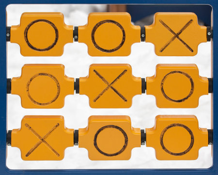Wooden game tic tac toe on outdoor playground. Cross zero game noughts and crosses on a winter snowy...