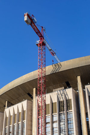 Reconstruction of a broken sports complex. The roof and facade of a large building, construction...
