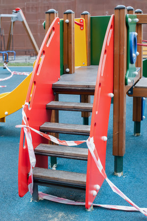 Playground with a striped fence tape, a ban on leaving the house. Sanitary treatment of a children's...