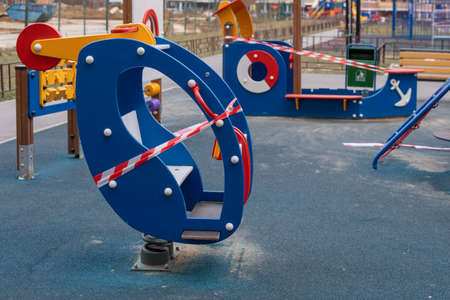 A playground with a wooden helicopter wrapped in barrier tape, stay home. Sanitization of a street sports complex, prevention of infection of the coronavirus pandemic covid-19の写真素材