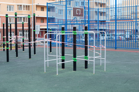 Street sports complex wrapped in striped red white tape, a ban to leave the house. Sanitization of...