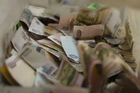 Russian money currency ruble, metal coins and paper notes in a box for collecting charitable...