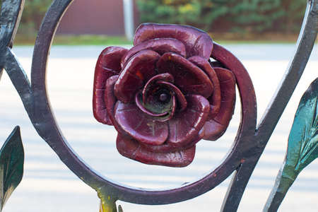 Metallic rose burgundy color, forged floral decoration close-upの写真素材
