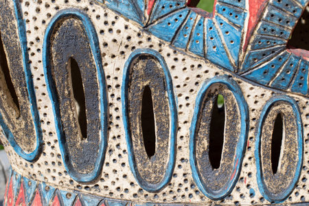 Clay surface with abstract ethnic pattern and holes. Abstract background backdrop texture of natural materialの写真素材
