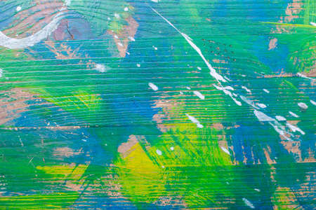 Abstract background, colored spots of paint on a wooden surface, green blue blot of oil paint texture, chaotic strokes of paintの写真素材