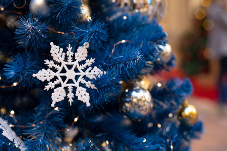 Christmas decoration card with a snowflake and silver balls on a blue artificial Christmas tree. winter event festive backgroundの写真素材