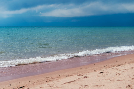 Beautiful blue sky and water of the Issyk Kul lake in Kyrgyzstanの写真素材