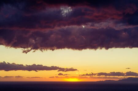 Dramatic purple clouds above the seaの写真素材