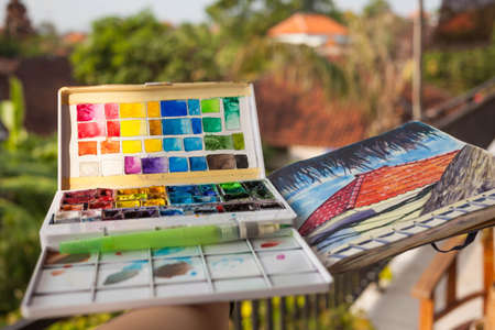 A box of watercolour paints. sketchbook outdoors.の写真素材