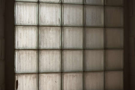 Dark texture of square glass pieces. Window pane.の写真素材