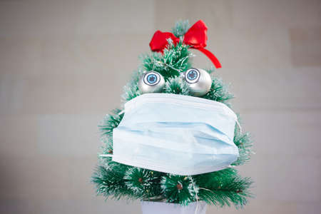 Cute concept with christmas tree girl wearing maskの写真素材