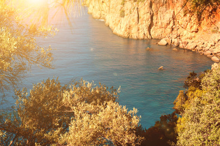 A beautiful sun lit bay with clean blue water and stone cliffs. Panoramic mountain view of the Black...