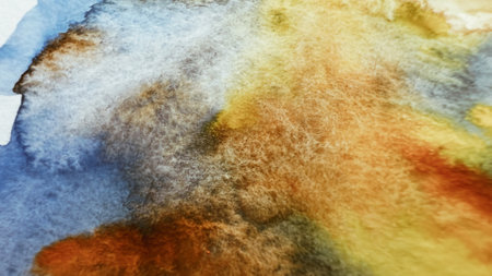 Macro texture of watercolor paint pigment on paper color orange brown yellow blue grey red. Abstract aquarelle wash. Watercolour mix close-up. Soft focus. film grain pixel texture. Defocused.の写真素材