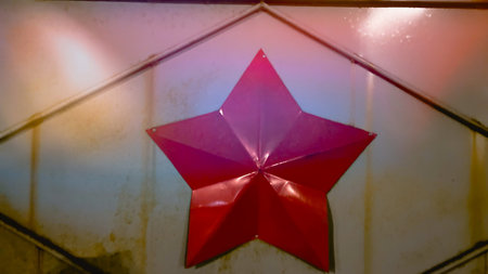 red star on metal gate of military object. Soviet red star as symbol of power. Vintage style...