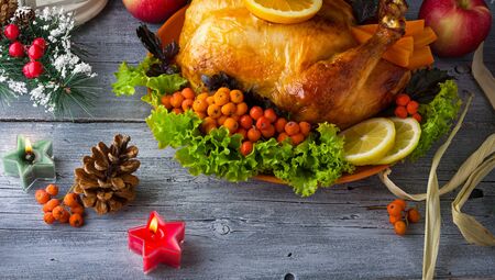 Turkey baked for thanksgiving with vegetables, branches and leaves. Fried chicken, Christmas dinnerの写真素材