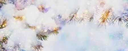 Beautiful Christmas snow background with fir tree branches, snow and lights, winter time, New year holidayの写真素材