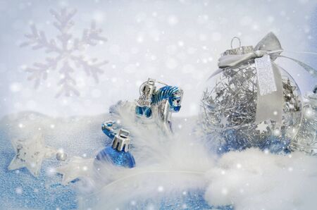 Christmas toys blue and white. Snowflakes, stars, horse and balloons on a snow background.の写真素材