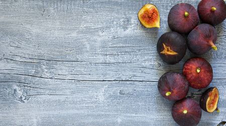 Bright ripe Fig fruit lying on rustic grey wooden background, top view, copy spaceの写真素材